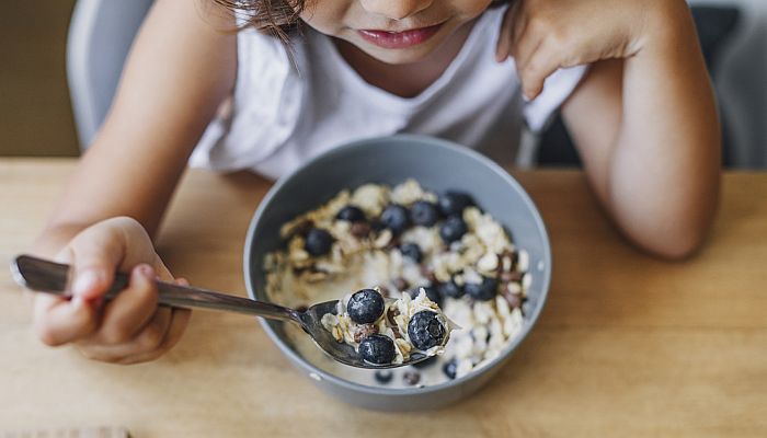 child eating a bowl of cereal